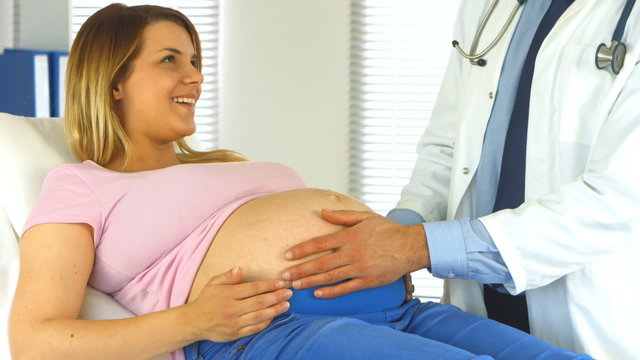 Doctor examining his pregnant patient