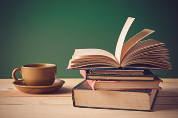 A pile of books on wooden table