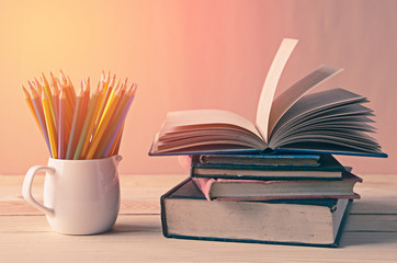 A pile of books on wooden table