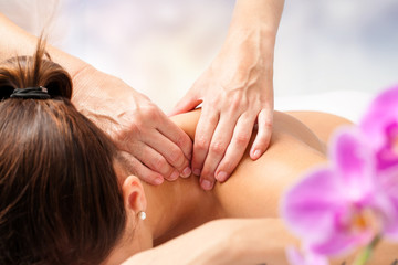 Detail of hands massaging female neck.