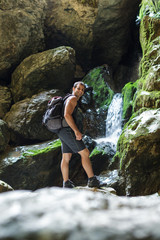 Hiker standing near a mountain river