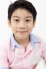 Portrait of Happy asian boy with smile face on gray background
