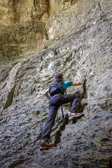 Teenage boy doing free climbing