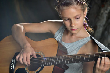  teenage girl playing guitar in the street