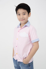 Little asian boy with smile face on gray background