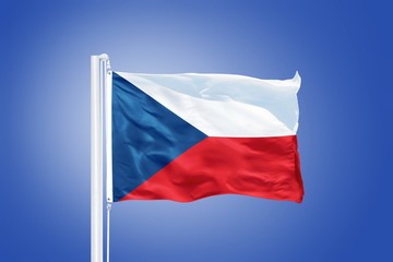 Fototapeta na wymiar Flag of Czech Republic flying against a blue sky