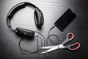 Scissors cut the wire from the headphones, leading to the phone, and thus stop the very loud...