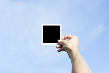 Girl hand holding a instant photo