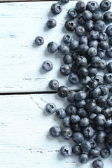 Blueberries on a blue wooden background
