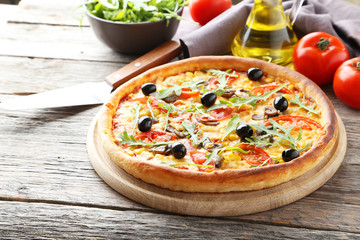 Fresh tasty pizza on grey wooden background