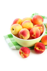 Fresh apricots in bowl on a white background