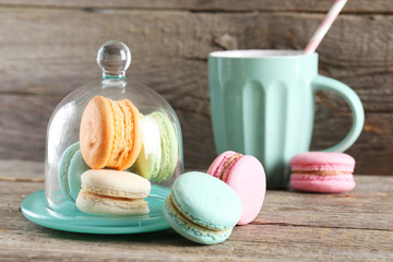 French colorful and tasty macarons on grey wooden table