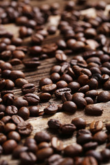 Roasted coffee beans on a brown wooden background