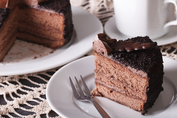 Chopped chocolate cake close-up on a plate. Horizontal
