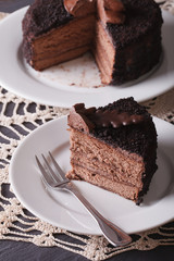 A piece of sliced dark chocolate cake close-up. vertical
