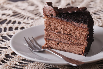 Fresh piece of chocolate cake on a table close-up. horizontal

