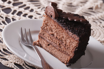A slice of chocolate truffle cake on a plate close-up. horizontal
