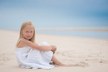 Fototapeta na wymiar Beautiful young girl on the beach