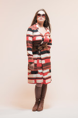 Sensual Brunette Woman with Sunglasses in Retro 1960s Dress.