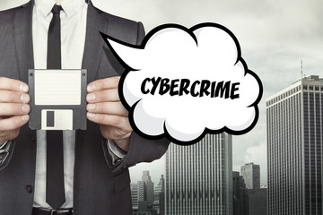 Cybercrime text on speech bubble with businessman holding