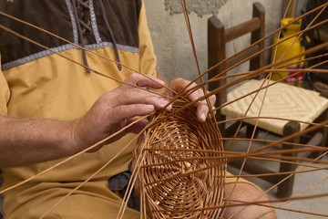 Fototapeta na wymiar craftsman making wicker baskets traditionally
