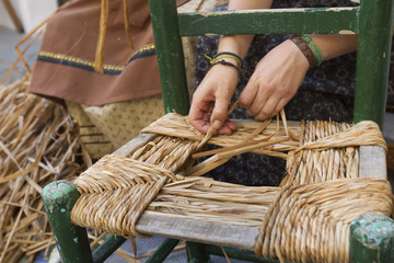 wicker chair woman doing traditional way