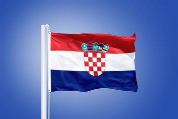 Flag of Croatia flying against a blue sky