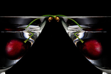 glass of drink with cherry closeup isolated on black background