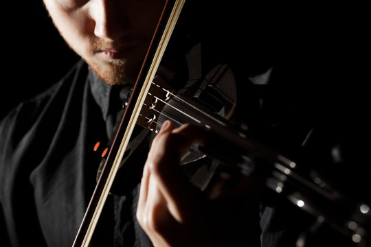 Close-up photo of man playing electric violin