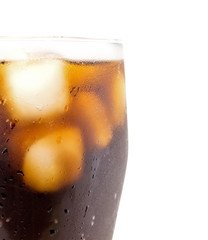 a large glass of cola with ice cubes closeup isolated on white background