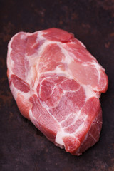 Raw pork steak neck on a dark background.selective focus