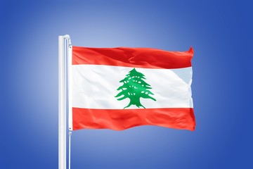 Flag of Lebanon flying against a blue sky