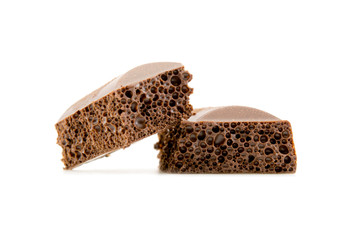 two slices of porous chocolate close-up texture isolated on a white background
