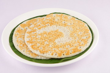 Traditional South Indian breakfast Dosa served on banana leaf.