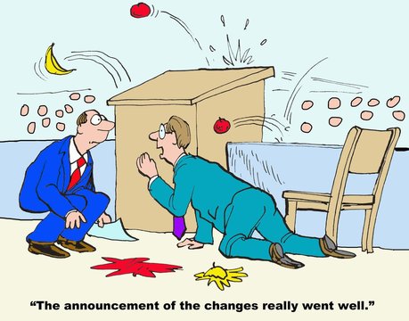 Business cartoon showing businessman crouching behind podium as audience throws rotten tomatoes at him.  Peer says, 'The announcement of the changes really went well'.