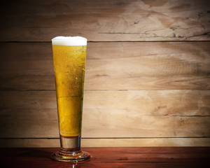 Glass beer on wood background.