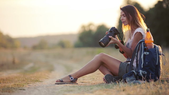 A young woman with a camera on a safari. Travel, tourism, adventure.