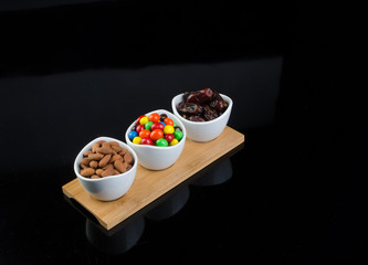 almond, chocolate and date on a background