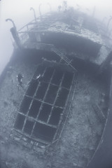 Divers on a deep underwater shipwreck