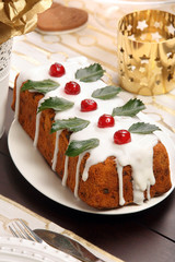 Christmas holly fruitcake on the table