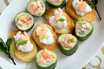 Fresh snack with salmon and shrimp on a plate
