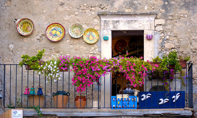 Peschici, apulia. old town balcony with small shop, artistic picture - obrazy, fototapety, plakaty