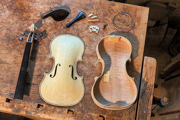 Elderly person building a violin