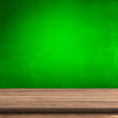 Vintage wood table in green cement wall.