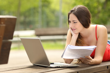 Student girl studying with a laptop in an university campus