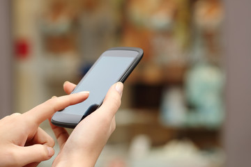 Woman hands buying online with a smart phone