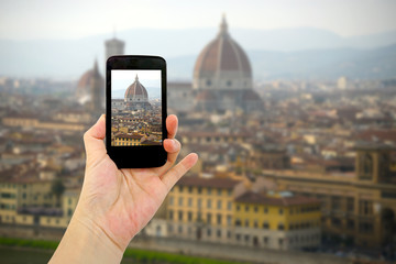 travel concept - tourist taking photo of Florence city on mobile gadget, Italy