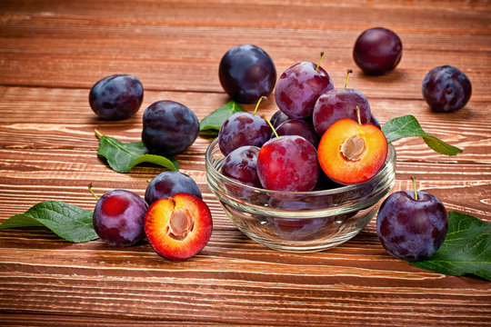 fresh plums on a wooden table