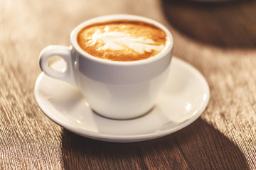  	
Cup of cappuccino on the table