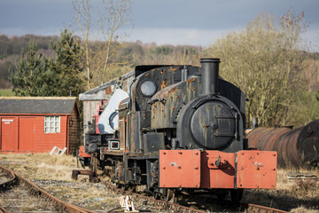 Fototapeta na wymiar Old vintage steam engine at an abandoned railway station.
